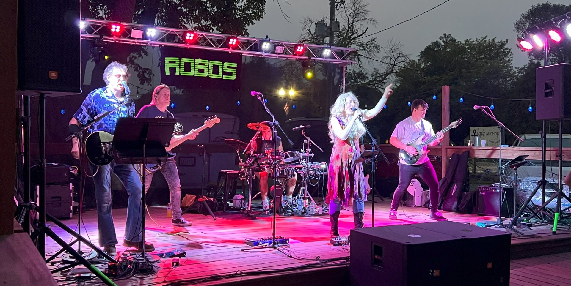 Robos band playing with people dancing and hands in the air.